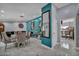 Open-concept living room with formal dining area, statement mirror, and accent wall at 601 Cragin Park Dr, Las Vegas, NV 89107
