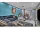 Open-concept living room with accent wall, a glass table with chairs, and a sectional corduroy sofa at 601 Cragin Park Dr, Las Vegas, NV 89107