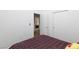 Bedroom with a plaid bedspread, open doorway, and sliding door closet at 610 Playa Del Sol Way, Henderson, NV 89015