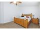 Bedroom with carpet flooring and a wooden bed frame complemented by side tables and lamps at 610 Playa Del Sol Way, Henderson, NV 89015