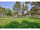 View of the community park with a playground and lush green space, perfect for families at 610 Playa Del Sol Way, Henderson, NV 89015