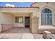 Welcoming front entrance featuring a covered porch and an arched window, enhancing curb appeal at 610 Playa Del Sol Way, Henderson, NV 89015