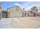 Home featuring a spacious two-car garage and well-kept driveway, blending functionality with classic design at 610 Playa Del Sol Way, Henderson, NV 89015