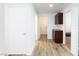 Hallway featuring wood-look flooring and access to various rooms, including one with cabinetry at 610 Playa Del Sol Way, Henderson, NV 89015