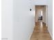Hallway with wood-look flooring and neutral paint leads to various rooms in the home at 610 Playa Del Sol Way, Henderson, NV 89015