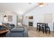 Bright living room boasts a fireplace, vaulted ceilings, and sliding glass door to the outdoor patio at 610 Playa Del Sol Way, Henderson, NV 89015