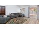 Spacious living room features a decorative rug, modern furniture and a glass sliding door to the backyard at 610 Playa Del Sol Way, Henderson, NV 89015
