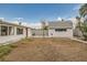 Spacious backyard with cinder block wall, storage shed, and mature trees at 613 Stanford St, Las Vegas, NV 89107