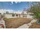 View of large backyard with detached shed, mature tree and cinder block wall at 613 Stanford St, Las Vegas, NV 89107