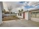 Backyard features a red back door, mature landscaping and block wall at 613 Stanford St, Las Vegas, NV 89107