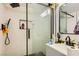 View of a bathroom shower with black hardware and textured white tiling at 613 Stanford St, Las Vegas, NV 89107