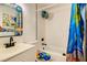 Bathroom with tiled shower over tub, decorative mirror and colorful themed toilet at 613 Stanford St, Las Vegas, NV 89107