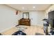 Minimalist bedroom with wood-style floors, dresser, and a doorway that lets in lots of light at 613 Stanford St, Las Vegas, NV 89107