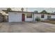 Charming single-story home featuring a minimalist front yard, unique front door, and a gated entrance at 613 Stanford St, Las Vegas, NV 89107