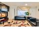 The home's cozy living room features hardwood floors, comfortable seating, and an eclectic modern rug at 613 Stanford St, Las Vegas, NV 89107