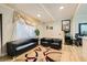 The home's cozy living room features hardwood floors, comfortable seating, and an eclectic modern rug at 613 Stanford St, Las Vegas, NV 89107