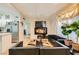Open-concept layout with cozy seating, modern décor, hardwood floors, and a glimpse of the kitchen at 613 Stanford St, Las Vegas, NV 89107