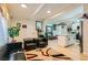 Open-concept layout with cozy seating, modern décor, hardwood floors, and a glimpse of the kitchen at 613 Stanford St, Las Vegas, NV 89107