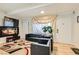 The home's cozy living room features hardwood floors, comfortable seating, and an eclectic modern rug at 613 Stanford St, Las Vegas, NV 89107