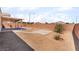 This gravel backyard features a covered patio at 6140 Passionate Ct, North Las Vegas, NV 89031