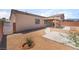 Backyard showcasing covered patio and well-maintained gravel landscaping at 6140 Passionate Ct, North Las Vegas, NV 89031
