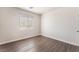 Bright bedroom features wood-look flooring, window and neutral paint palette at 6140 Passionate Ct, North Las Vegas, NV 89031