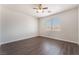 Spacious bedroom with wood-look floors, a ceiling fan, and a bright window at 6140 Passionate Ct, North Las Vegas, NV 89031