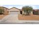 Charming single-story home featuring a low maintenance desert landscape and attached two-car garage at 6140 Passionate Ct, North Las Vegas, NV 89031