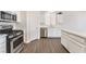 Modern kitchen with stainless steel appliances, white cabinets, and stone countertops at 6140 Passionate Ct, North Las Vegas, NV 89031