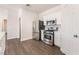 Kitchen features stainless appliances, white cabinets, and view to the pantry at 6140 Passionate Ct, North Las Vegas, NV 89031