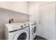 Laundry room features a modern washer and dryer and plenty of shelving at 6140 Passionate Ct, North Las Vegas, NV 89031