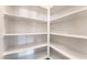 Walk-in pantry features painted white shelving for ample storage at 6140 Passionate Ct, North Las Vegas, NV 89031