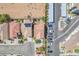An aerial view showcases cozy homes with a blend of desert landscaping, apartments and organized parking at 6247 Sugartree Ave, Las Vegas, NV 89141