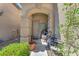 Inviting front porch featuring decorative accents and potted plants, leading to the home's entrance at 6247 Sugartree Ave, Las Vegas, NV 89141