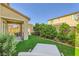Well-manicured backyard with artificial turf and privacy landscaping, plus a comfortable daybed for lounging at 625 Loyalty Ct, Henderson, NV 89011