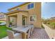Beautiful backyard featuring a covered patio, outdoor dining space, and easy-to-maintain artificial turf at 625 Loyalty Ct, Henderson, NV 89011