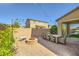Inviting backyard with a brick-paved patio, a cozy fire pit, outdoor dining, and lush landscaping at 625 Loyalty Ct, Henderson, NV 89011