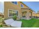 Relaxing backyard featuring a daybed, covered patio, outdoor dining area, and lush artificial turf at 625 Loyalty Ct, Henderson, NV 89011