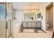 Bathroom with dual sinks, soaking tub, and glass-enclosed shower at 625 Loyalty Ct, Henderson, NV 89011