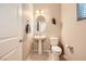 Powder room features pedestal sink, modern fixtures, and neutral decor at 625 Loyalty Ct, Henderson, NV 89011