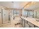 Bathroom with dual sinks, soaking tub, and glass-enclosed shower at 625 Loyalty Ct, Henderson, NV 89011