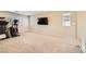 Bright bonus room with a large window, TV, and a home fitness machine at 625 Loyalty Ct, Henderson, NV 89011