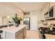 Contemporary kitchen featuring stainless steel appliances, gas cooktop, and center island with barstool seating at 625 Loyalty Ct, Henderson, NV 89011