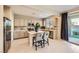Well-lit kitchen with stainless steel appliances, gray cabinets, and a cozy breakfast bar area at 625 Loyalty Ct, Henderson, NV 89011