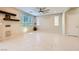Open living room with tile flooring, floating shelves, and lots of natural light from the windows at 625 Loyalty Ct, Henderson, NV 89011