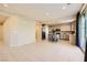 Open-concept living room and kitchen area with tile floors and access to the outdoor patio at 625 Loyalty Ct, Henderson, NV 89011