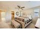 Spacious primary bedroom with ceiling fan, large bed, and neutral carpeting at 625 Loyalty Ct, Henderson, NV 89011