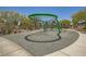 A unique green playground structure sits atop a modern surface, surrounded by lush landscaping at 625 Loyalty Ct, Henderson, NV 89011