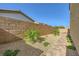 Low-maintenance side yard featuring desert landscaping, brick accents, and ample privacy wall at 625 Loyalty Ct, Henderson, NV 89011