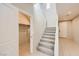 Carpeted staircase with white railing in a light and airy foyer at 625 Loyalty Ct, Henderson, NV 89011